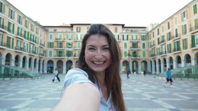Young happy woman taking a selfie in plaza mayor, palma de mallorca