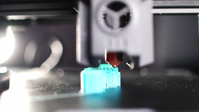 A close-up of a modern 3D printer in the process of printing a part. High quality 4k footage