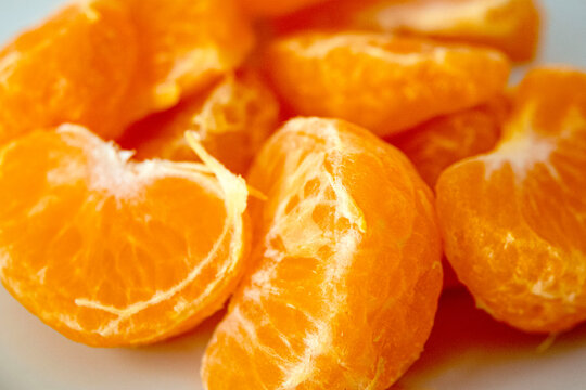 Mandarin orange slices arranged neatly on a plate