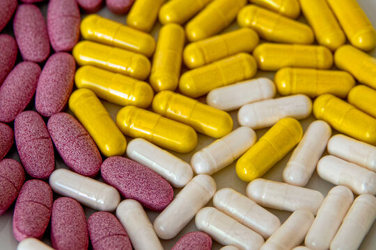 Colorful tablets and capsules of food supplements