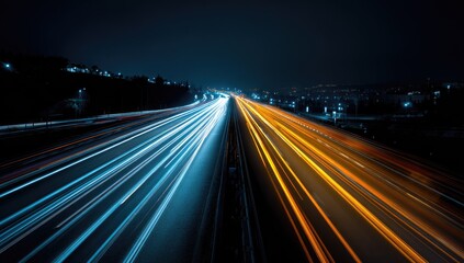 Obraz premium Long exposure shot of a highway at night with vibrant blue and orange light trails