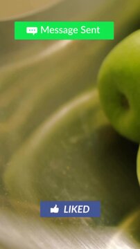 Vertical video: Pointer clicking over green apples in sink causing badges appearing or fading for fo