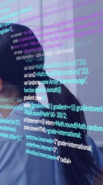 Vertical video: Woman standing in office, projected code scrolling over back and wall for tech demo