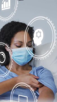 Vertical video: Patient reclining gloved hand near exposing arm prepping for shot with medical HUD