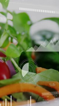 Vertical video: Showing HUD, camera zooming into bowl of salad at studio tabletop, revealing tomato