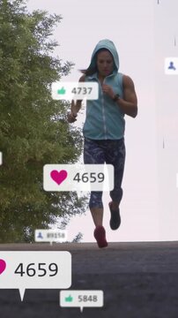 Vertical video: Runner starting run down to cam checking wrist as heart counts updating for fitness