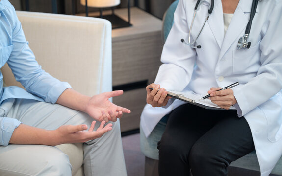 Psychiatrist doctor or psychologist talking and psychology question with patient for mental health assessment.