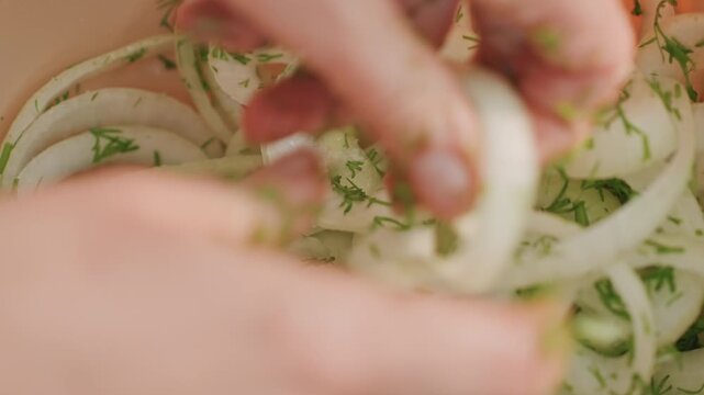 Camping dill onion closeup sensory mix, close focus on hands separating delicate onion rings coated with chopped dill in bowl, moist texture, soft sunlight, intimate camp cook scene, finishing touch