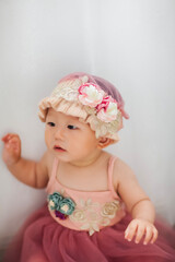 Fototapeta premium Cute Asian baby girl wearing a woolen hat