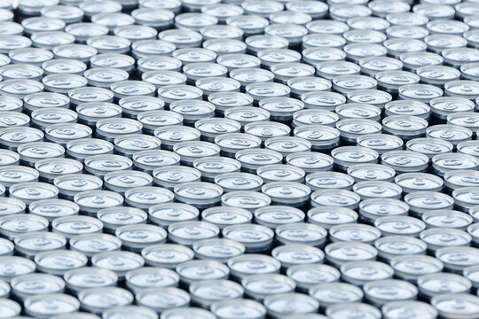 Stack of aluminum beer cans forming repetitive industrial