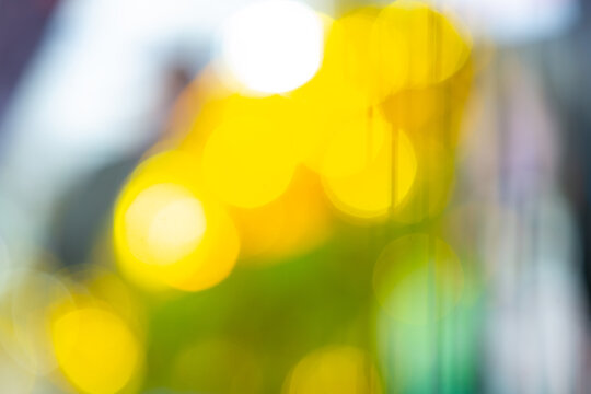 Abstract colorful bokeh lights background with yellow and blue glow