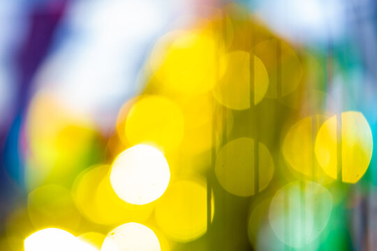 Abstract colorful bokeh lights background with yellow and blue glow