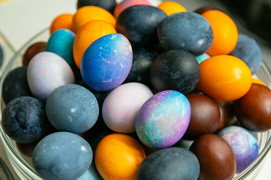 Colorful dyed Easter eggs in glass bowl &ndash; traditional holiday decoration