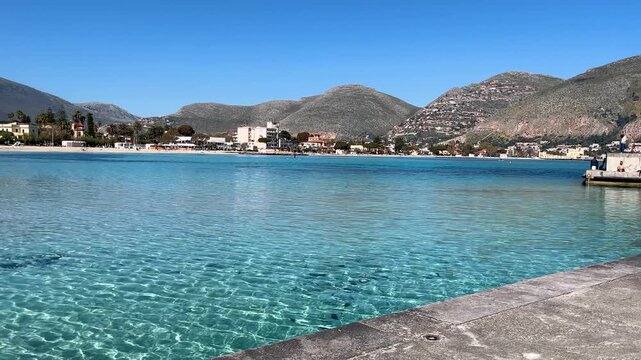 Crystalline turquoise sea water ripples in a sunny coastal town mondello beach in sicily