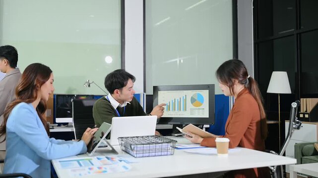 usiness team discuss at meeting room. working together with laptop ,tablet and smart phone on desk Financial accountant , planner , meeting , introduction concept.