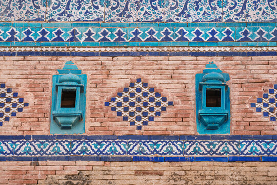 Detail view of brick and blue ceramic tiles decor on ancient medieval Baha'al Halim tomb, Uch Sharif, Bahawalpur, Punjab, Pakistan
