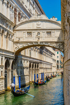 Venice, Italy - 29 March 2026: View of the Bridge of Sighs, a vision in pale stone, arches gracefully over the canal as gondolas glide on emerald waters below.