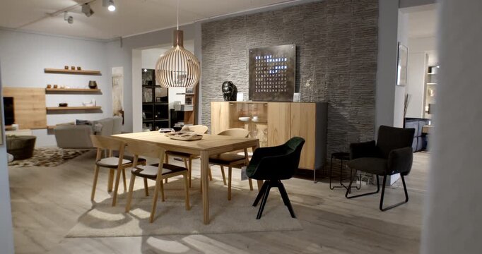 Modern living room and dining area interior with wooden table and stone wall decor in a showroom
