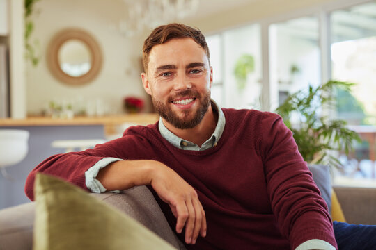Mid adult man relaxing at home while looking at camera