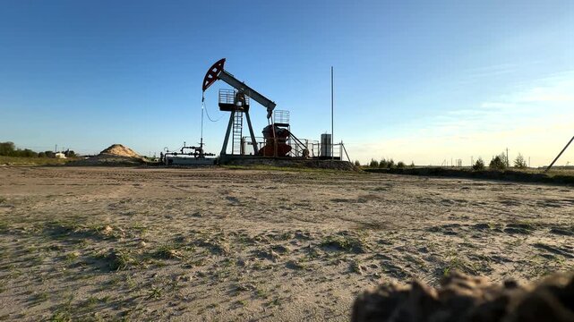 Extraction of petroleum. Oil Pump Jack on blue. Oil Field. Petrolium crude Industrial. Crude pump jack working.. Extraction of petroleum in oilfield. Crude petroleum industry