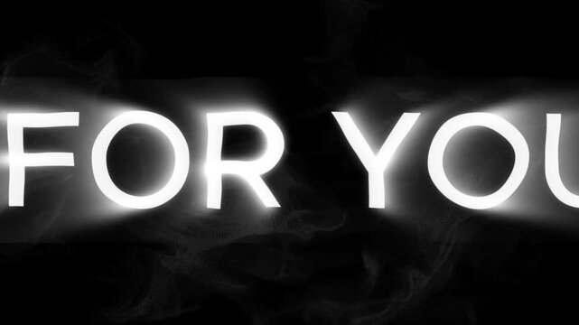 Typography glowing with white light emerges from deep darkness to display a message made for you.