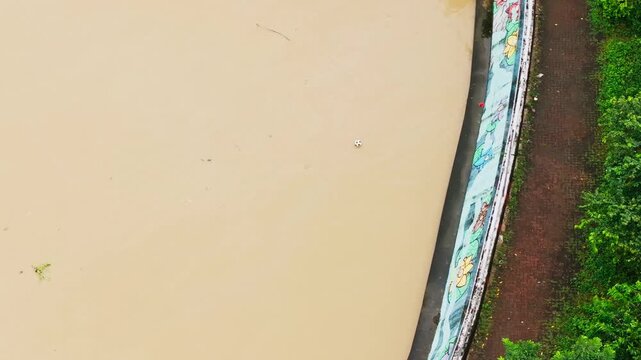 Top down drone view of Pasig River debris and muddy water in Makati Metro Manila