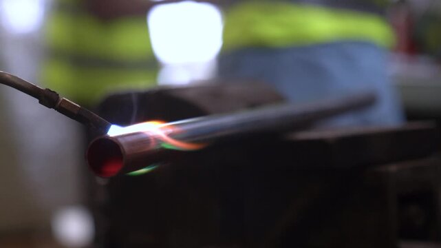 Copper Pipe Being Heated Up With A Blow Torch During Assembly In A Industrial Metal Manufacturing Plant.
