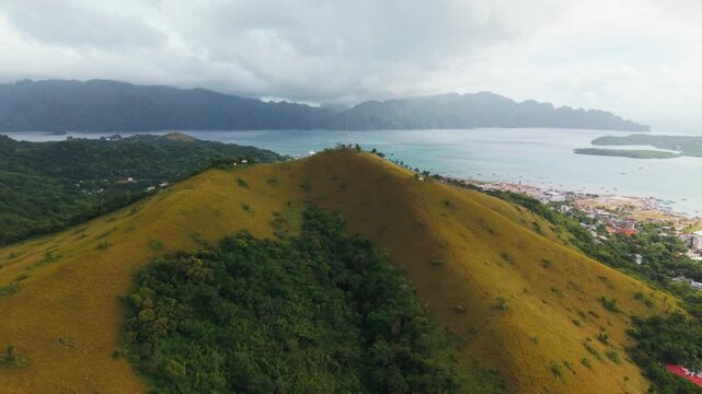 Drone shot of Mount Tapyas hill Coron Philippines with cross and coastal view