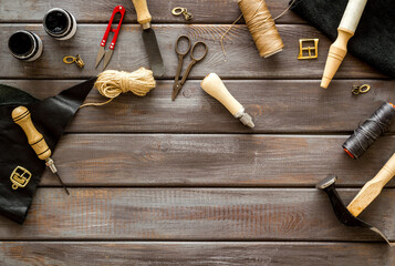 Leather craft work tools flat lay. Tailor or shoemaker on workplace, top view