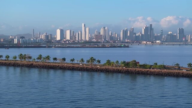 Aerial drone shot of the Amador Causeway in Panama, zooming in and then showing the Biomuseo and Ancon Hill in the background