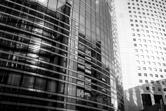 Urban monochrome study of modern architecture captures building facade in glass where contrast lines and geometry shape a stark visual narrative