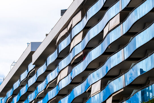 Diagonal urban geometry on modern facade shows windows repetition and reflection across building surfaces for abstract architecture observation