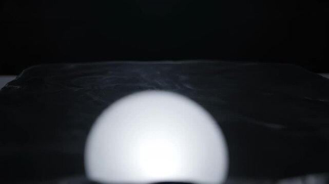 Stark White Egg on Dark Textured Background