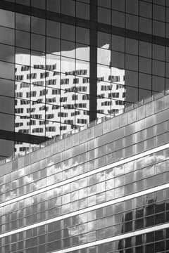Monochrome glass facade of modern building with windows lines and contrast plus reflection presenting architectural mood for editorial use