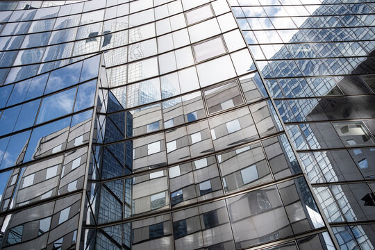 City skyline mood with modern skyscraper glass facade windows and sky reflection highlighting office building architecture in an urban setting