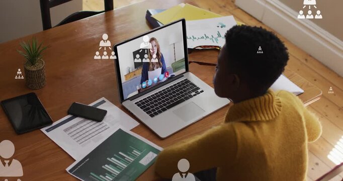Animation of user icons floating over african american woman having video call on laptop
