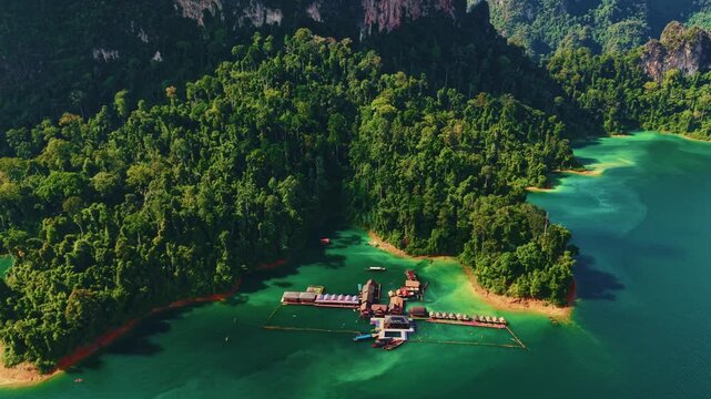 Floating resorts in Khao Sok national park surrounded by lush jungle in of Cheow Lan lake, Thailand Aerial view.