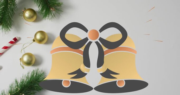 Animation of christmas bell icons over christmas decorations against grey background