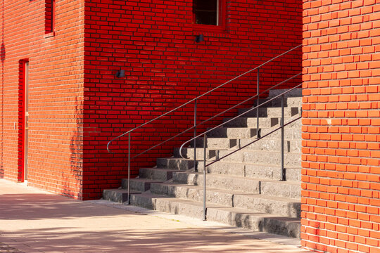 Minimal urban architecture exterior stairs in concrete beside brick wall showing geometry pattern and rich texture background