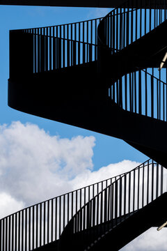 Abstract architecture staircase spiral silhouette against sky with geometry lines pattern and strong contrast for design background