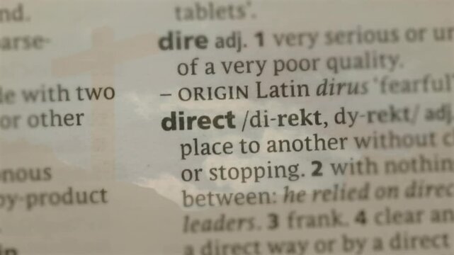 Lens tightening focus on dict column, revealing direct term with faint sky reflection for education