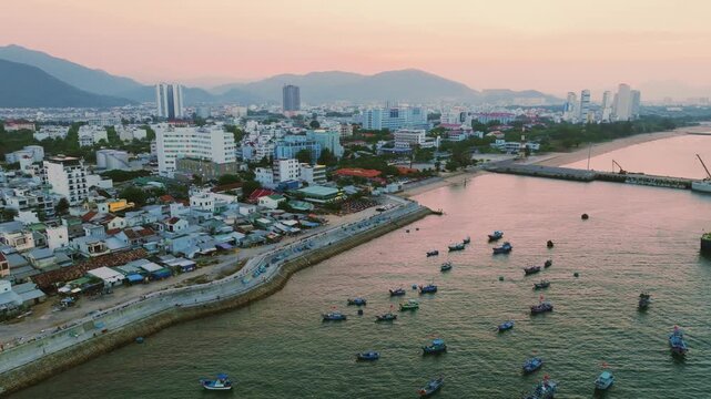 Nha Trang city skyline and traditional fishing port aerial panorama, Vietnam.
the striking contrast between the traditional Lang Chut fishing village and the modern high-rise skyline of Nha Trang.