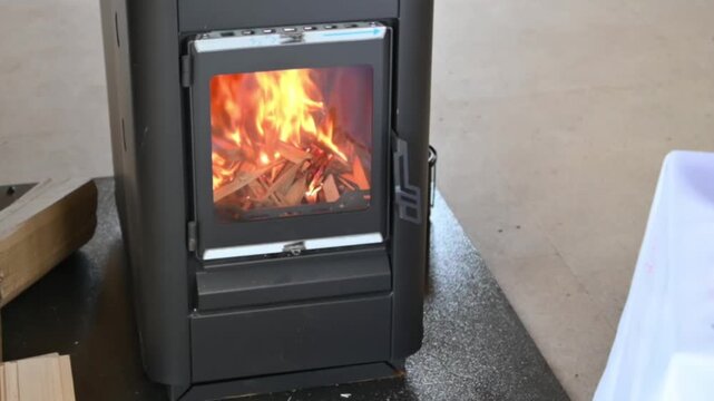 Cozy small fireplace with a burning fire in a home interior
