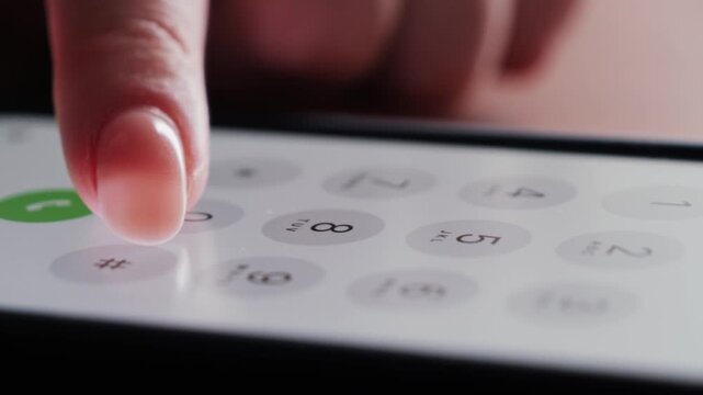 Close up of finger dialing pin or phone number on screen smartphone.