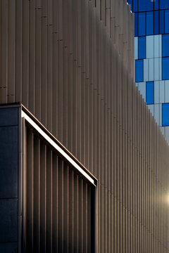 Abstract detail of modern metal facade lines on urban building architecture with repeating pattern creating sleek contemporary design texture
