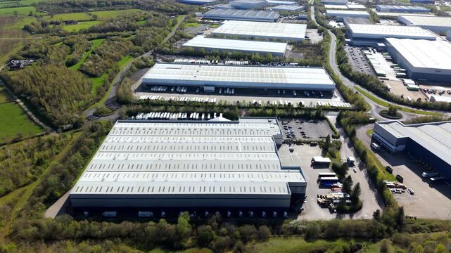 Aerial drone view of massive warehouses with blue ombre cladding at Magna Park Lutterworth UK
