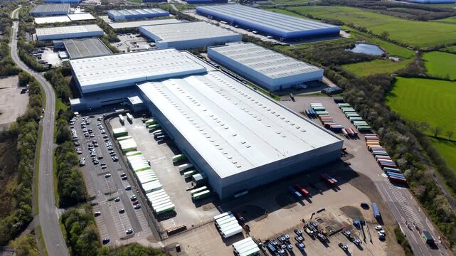 Aerial drone view of massive warehouses with blue ombre cladding at Magna Park Lutterworth UK