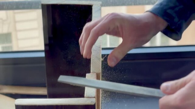 The video shows the process of fine-tuning a part using a file to achieve a precise shape or smoothness.