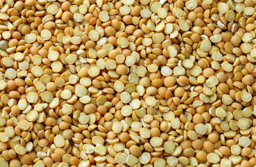 Fototapeta premium Pea grains in big pile on table close up. Large amount of yellow pea seeds