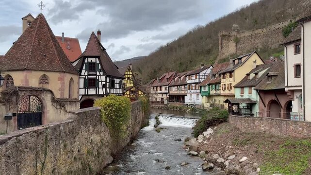 Traditional timberframe houses at Kaysersberg town centre. Motion of Weiss river water. Panoramic, scenic view. Oberhof chapel. Kaysersberg, Alsace, France